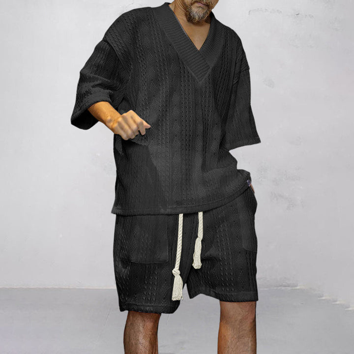 Back view of men's relaxed V-neck shirt & shorts lounge set. Comfort-focused summer casual wear.