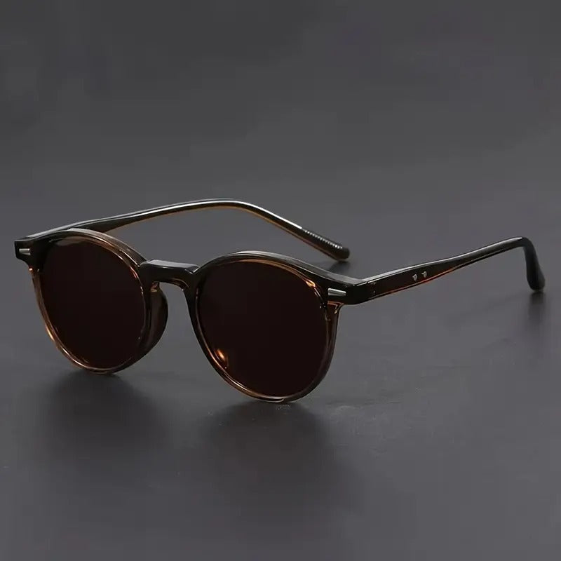 Stylish men's vintage round sunglasses with green lenses and a brown frame. Perfect retro fashion accessory.