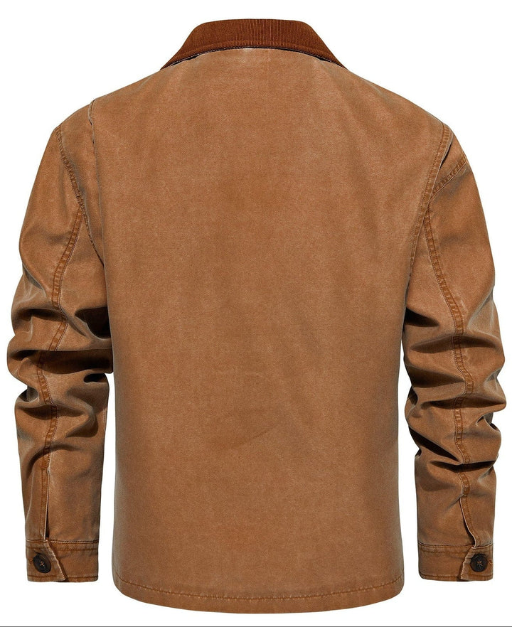 Man's hand reaching for a button on the black canvas jacket, showing the quality and finish.