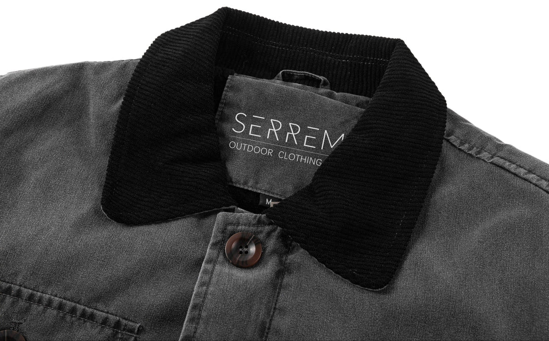 Full-length shot of a man in a black canvas utility jacket, suitable for rugged everyday wear.