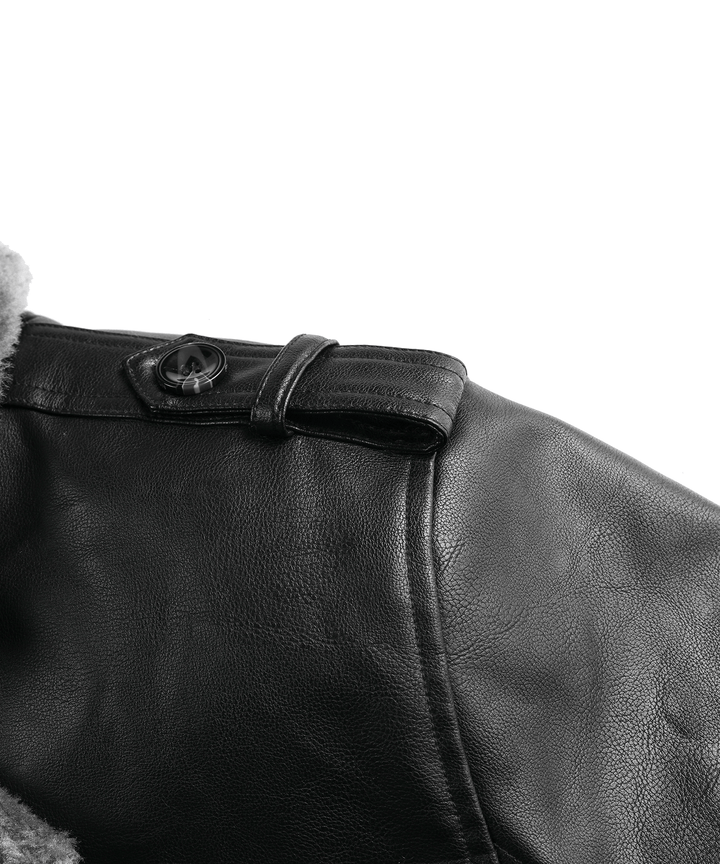 Close-up of the stitching detail on the men's black PU leather arctic winter coat, durable design
