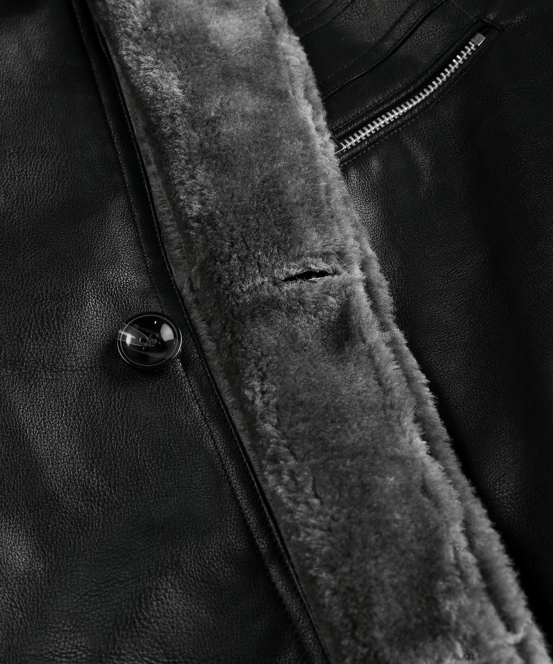 Black men's arctic winter jacket on a hanger, highlighting its rugged and insulated features