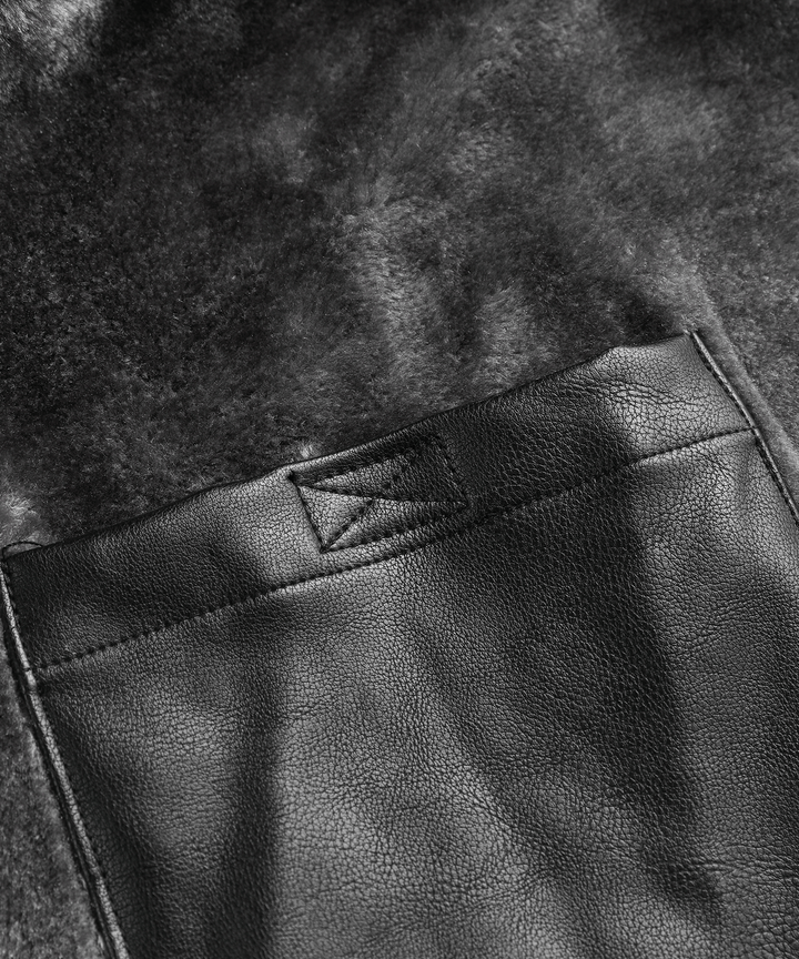 Detail of the high collar and durable zipper on the men's rugged black winter jacket