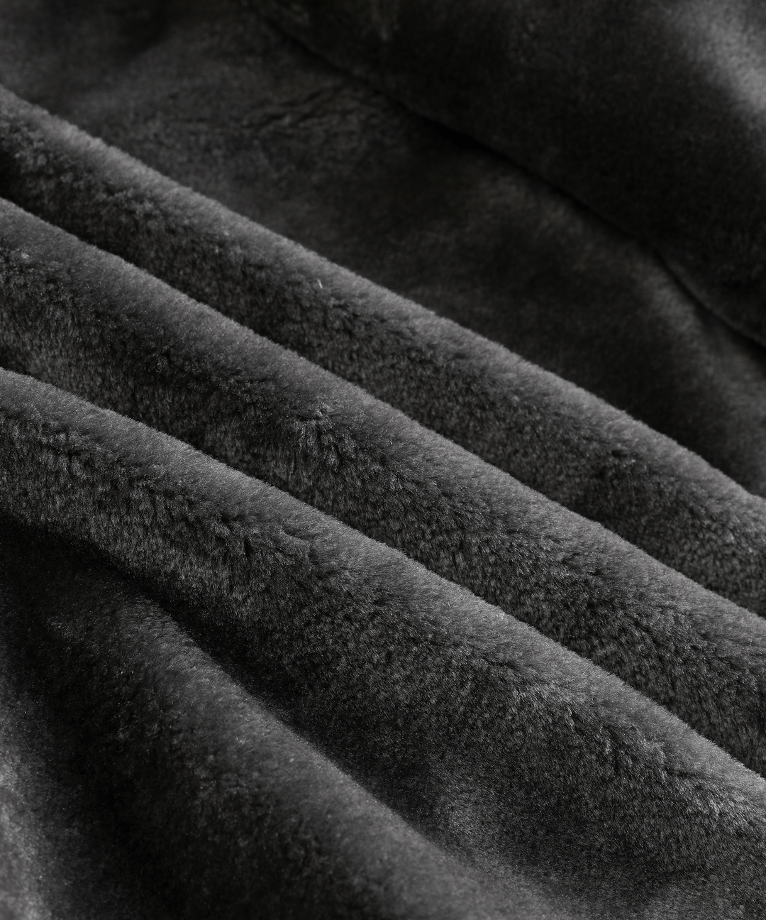 The rugged men's arctic winter coat with its hood up, providing extra cold weather protection