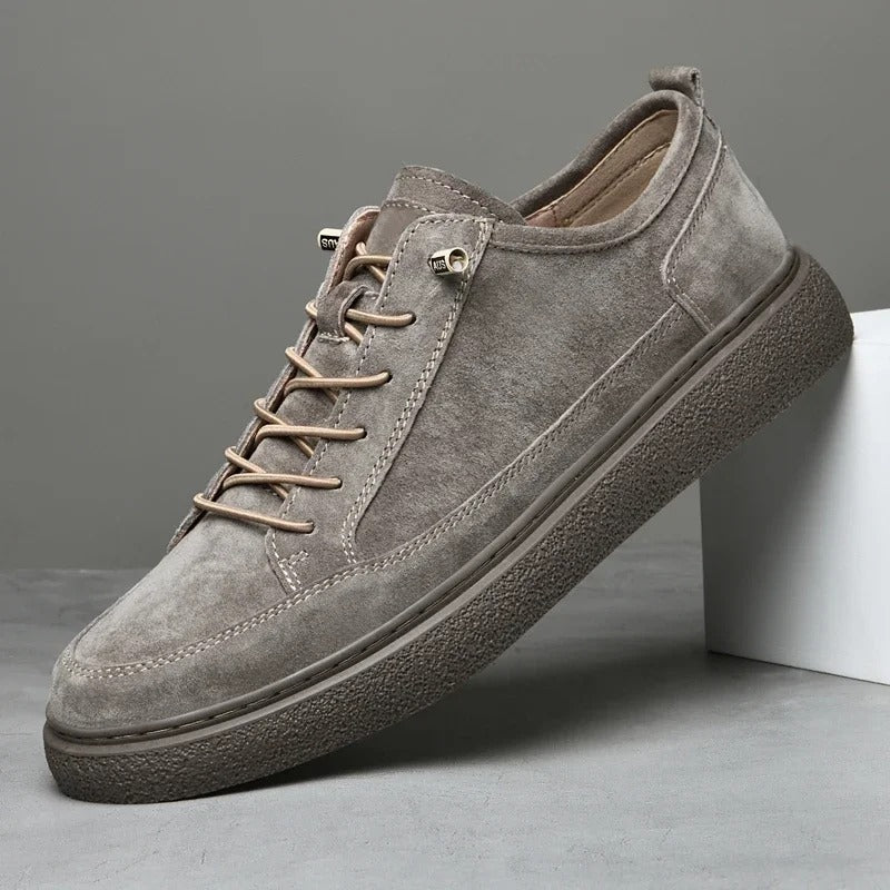 A pair of men's gray suede low-top sneakers, ideal casual footwear for any occasion.