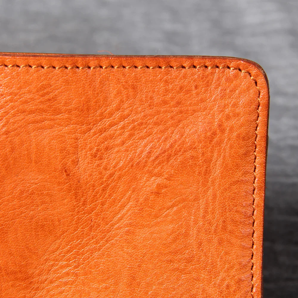 Group of men's slim bifold leather wallets in various colors like black, brown, and tan.