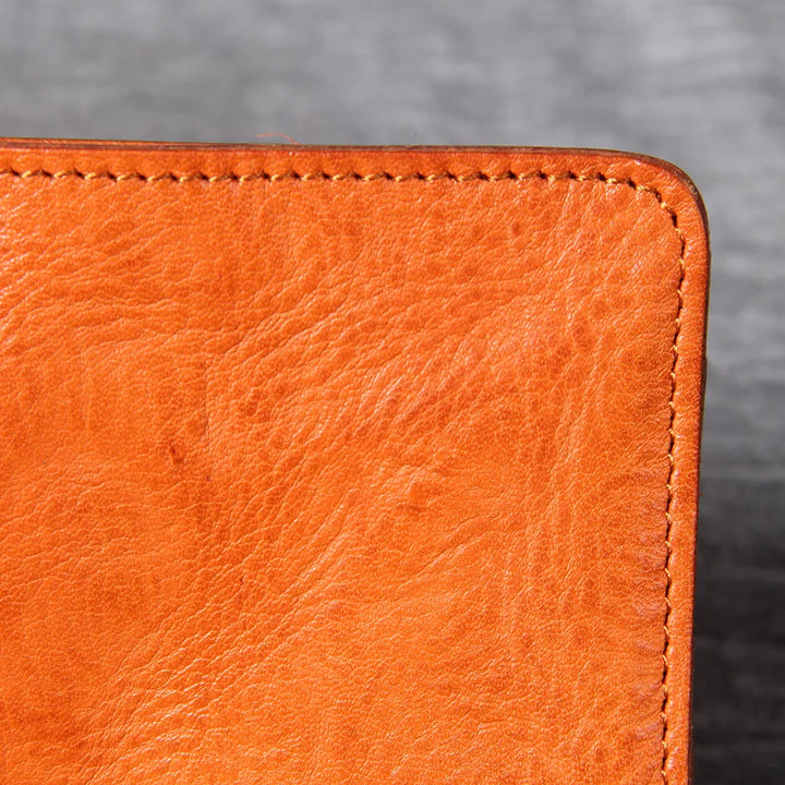Group of men's slim bifold leather wallets in various colors like black, brown, and tan.