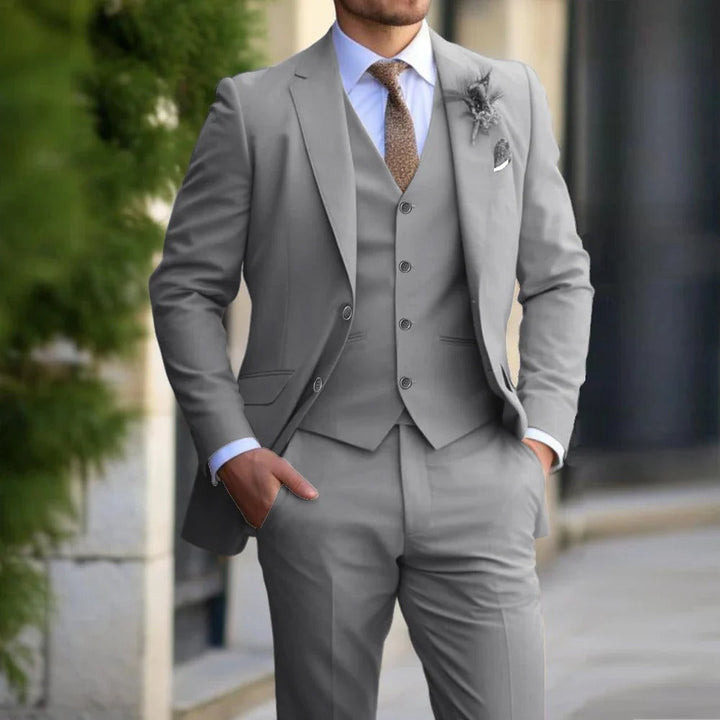 Stylish men's 3-piece suit; slim fit blazer, vest, and pants set, ideal for modern formal wear.