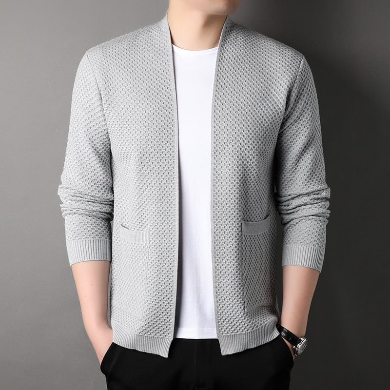 Close-up of a men's slim fit knitted cardigan showing texture and functional front pockets.