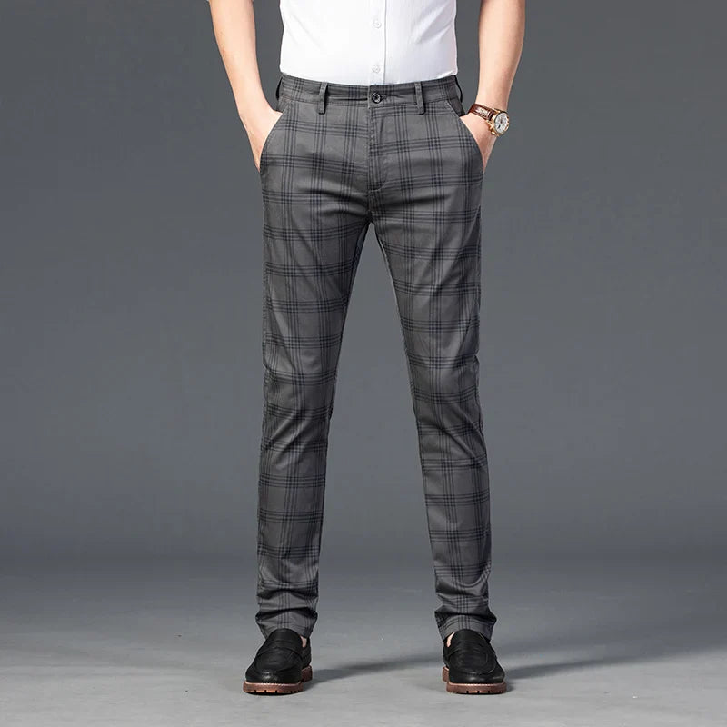 Stylish men's black and white plaid slim fit trousers, suitable for business and casual outfits.