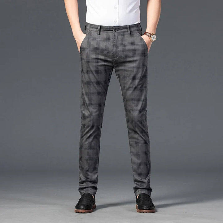 Stylish men's black and white plaid slim fit trousers, suitable for business and casual outfits.