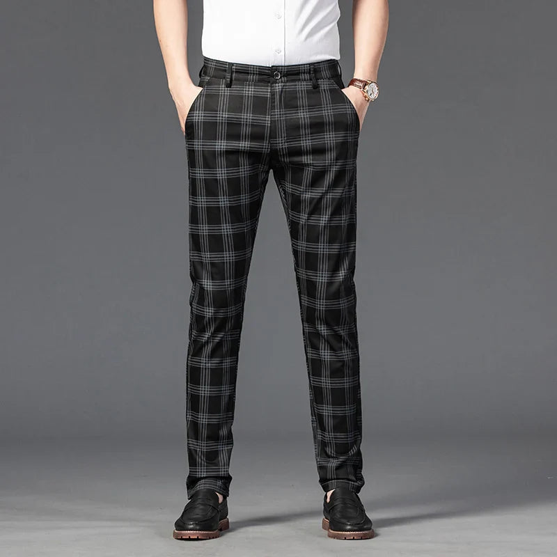 Model wearing men's slim fit plaid formal trousers, showcasing the flattering cut and design.