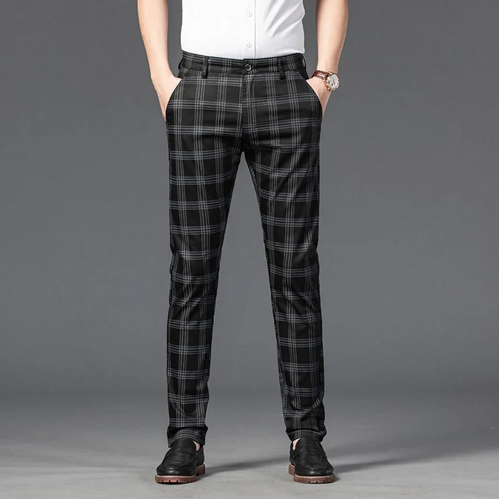 Model wearing men's slim fit plaid formal trousers, showcasing the flattering cut and design.