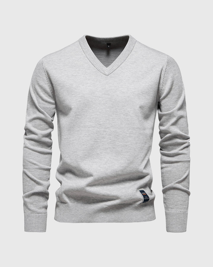 Close-up of the V-neckline and ribbed detailing on a men's cotton blend pullover