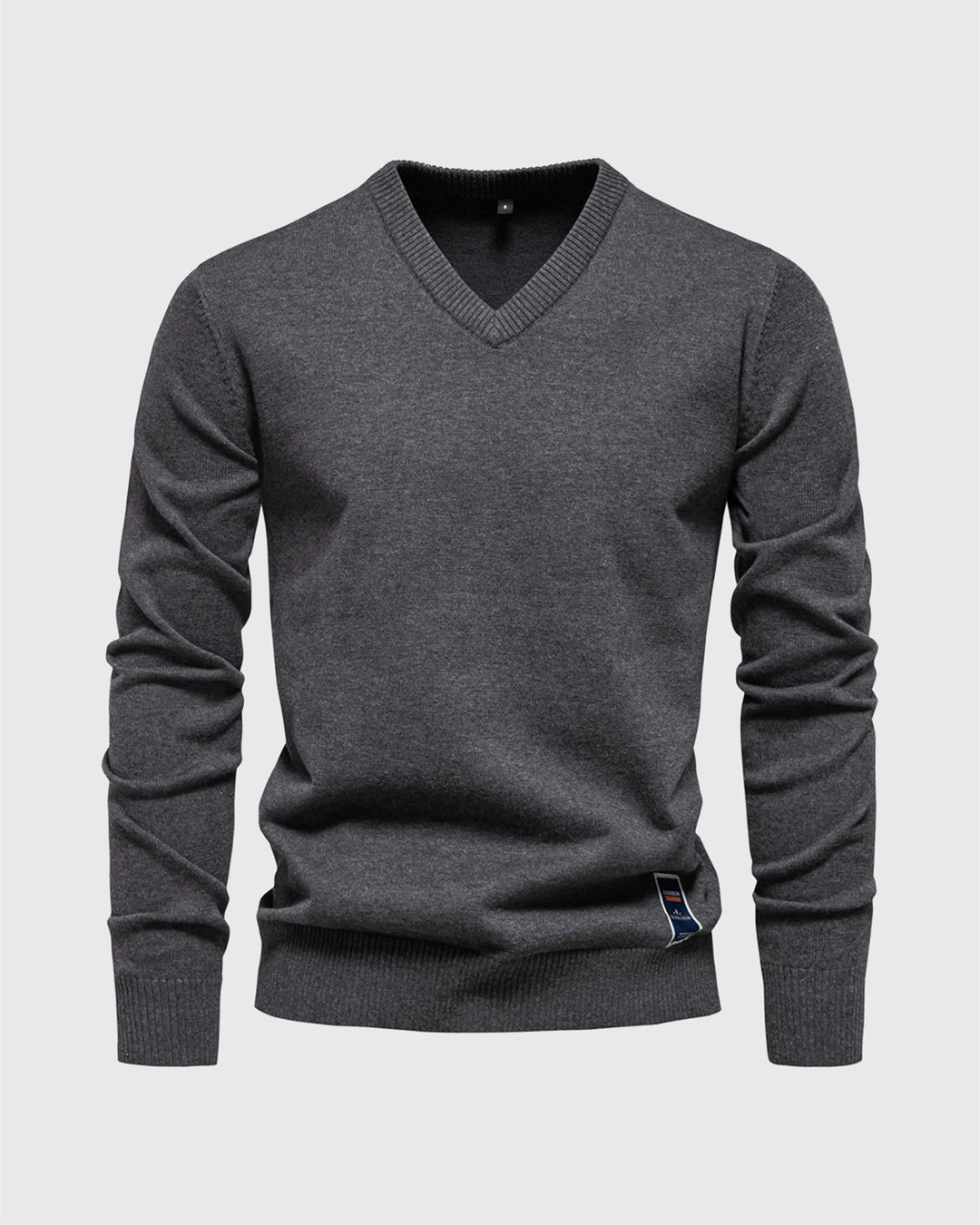 Model wearing a men's slim fit ribbed V-neck pullover sweater with jeans