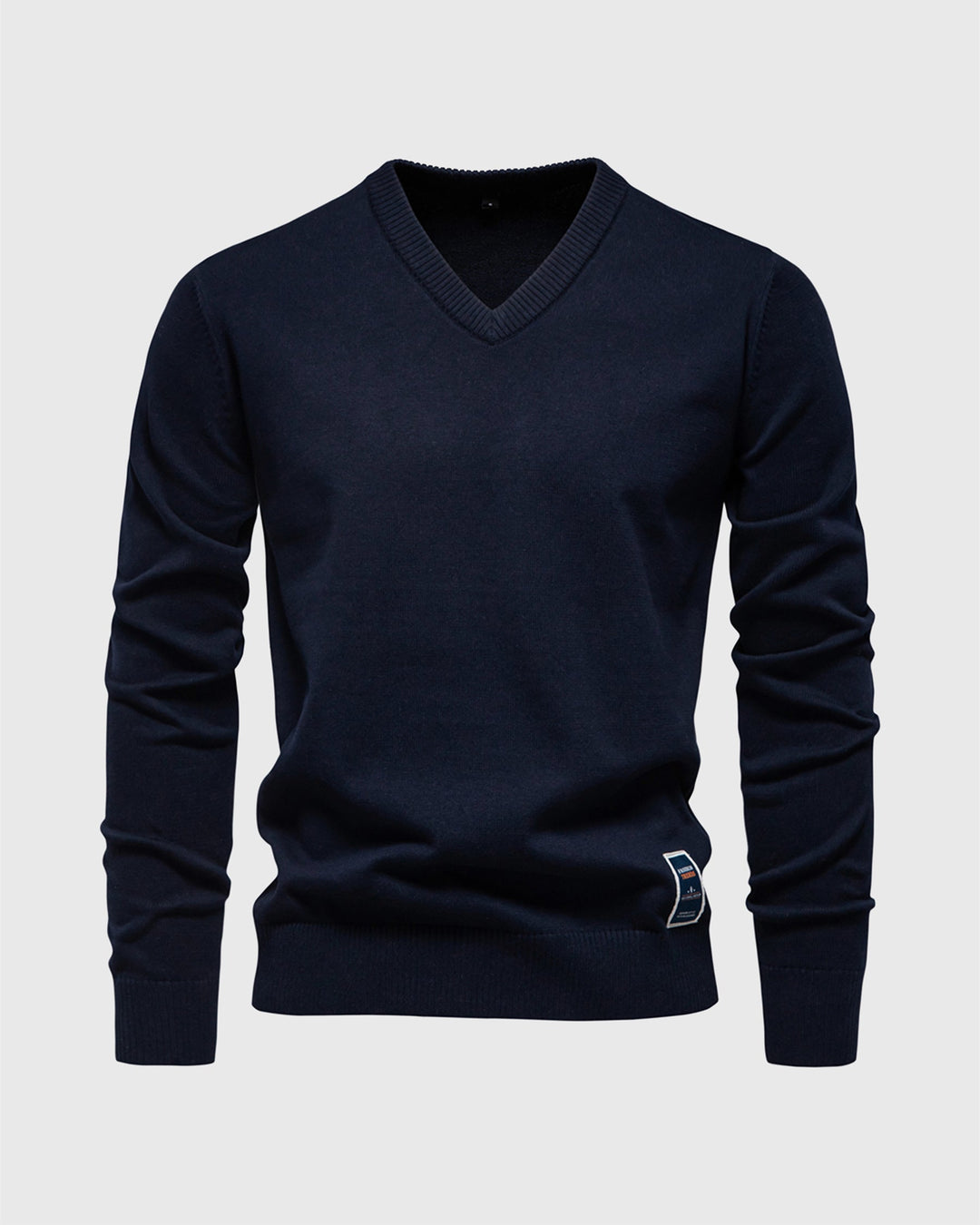 Detail of the ribbed cuffs and hem on a men's cotton blend V-neck pullover sweater