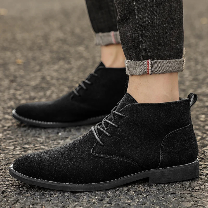 Detail of the lacing on men's soft suede chukka boots, enhancing the classic design.