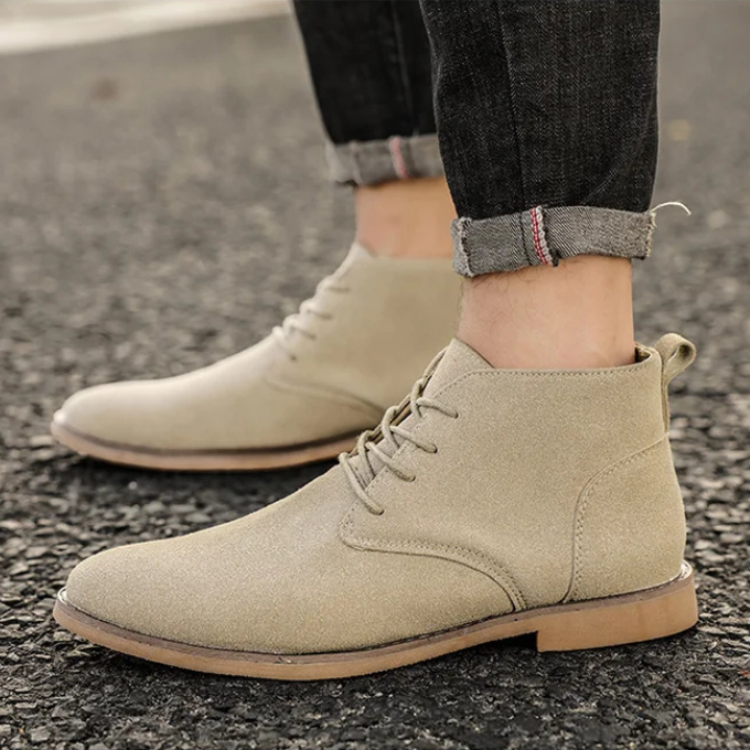 Pair of men's dress chukka boots in suede, versatile for various outfits.