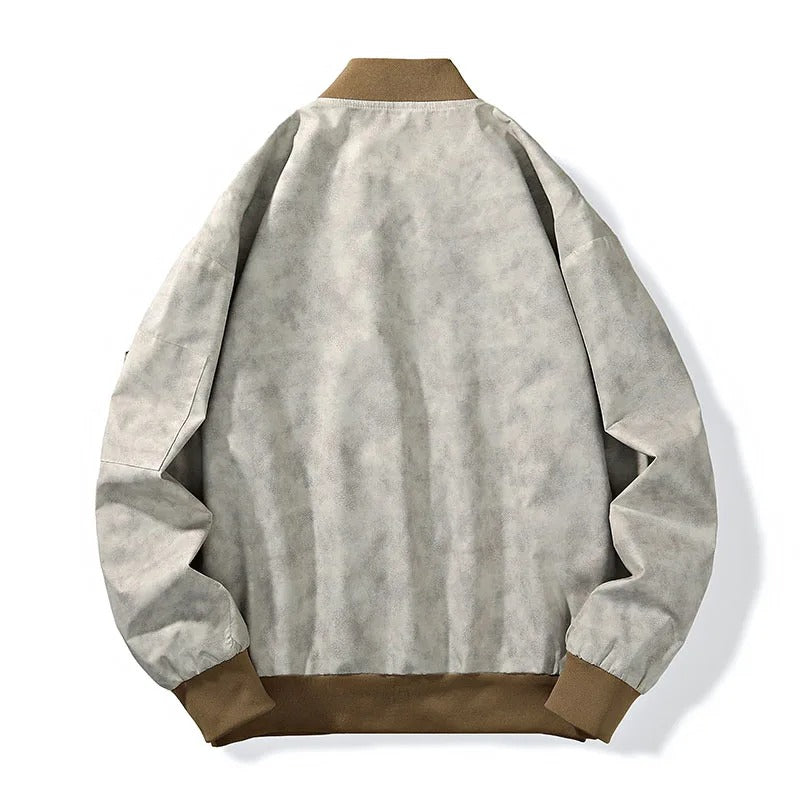 Stylish man wearing a stonewash canvas bomber jacket, a key piece of men's outerwear
