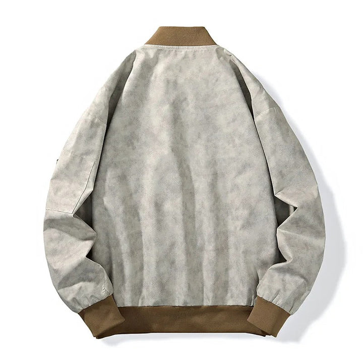 Stylish man wearing a stonewash canvas bomber jacket, a key piece of men's outerwear