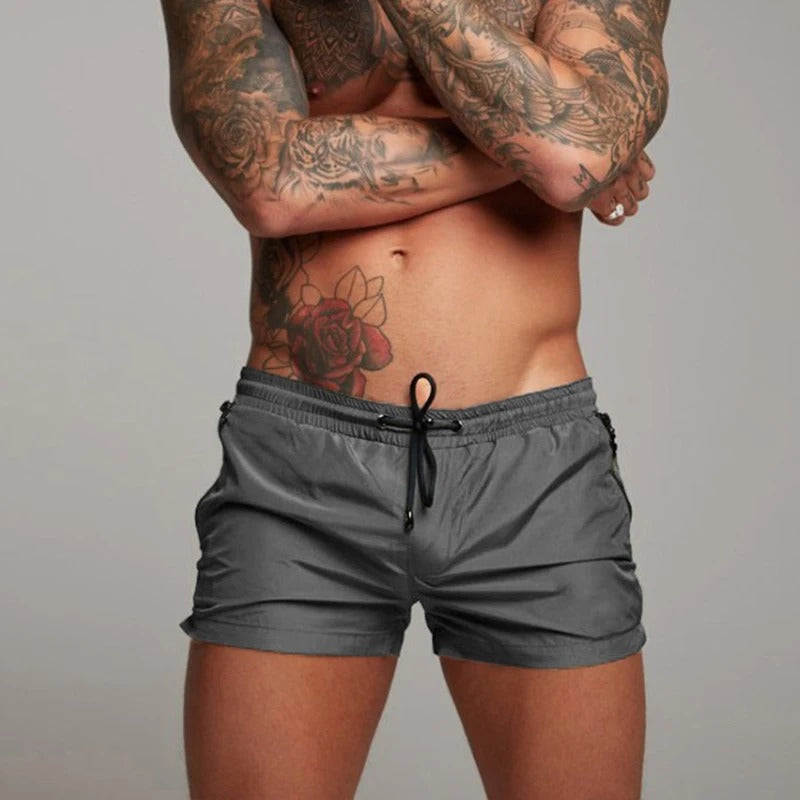 Men's stretch quick-dry swim trunks with adjustable drawstring waist for comfort at the beach or pool.