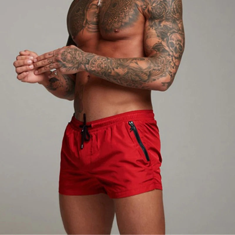 Stylish men's quick-dry beachwear swim trunks with stretch fabric and an adjustable drawstring for summer comfort.