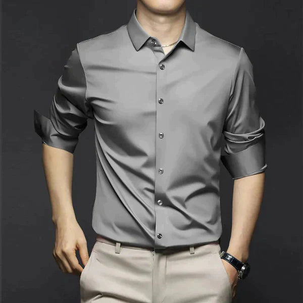 Man wearing a black slim fit dress shirt, styled for a modern and professional look.