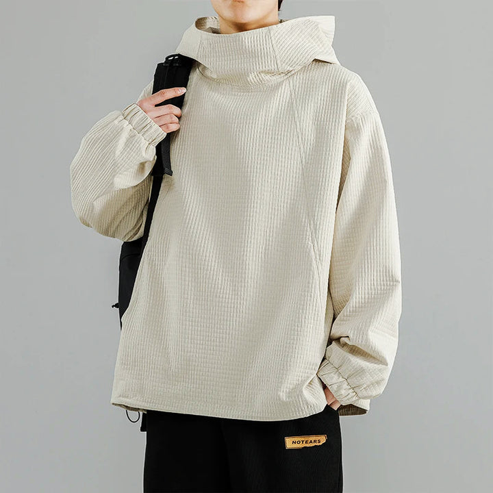 Man wearing a black structured fleece hoodie, showcasing its comfortable fit and style