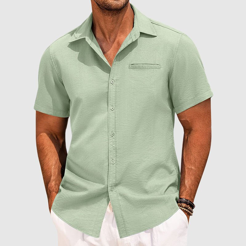Close-up of a men's stylish short sleeve button-down summer shirt, featuring a functional chest pocket.