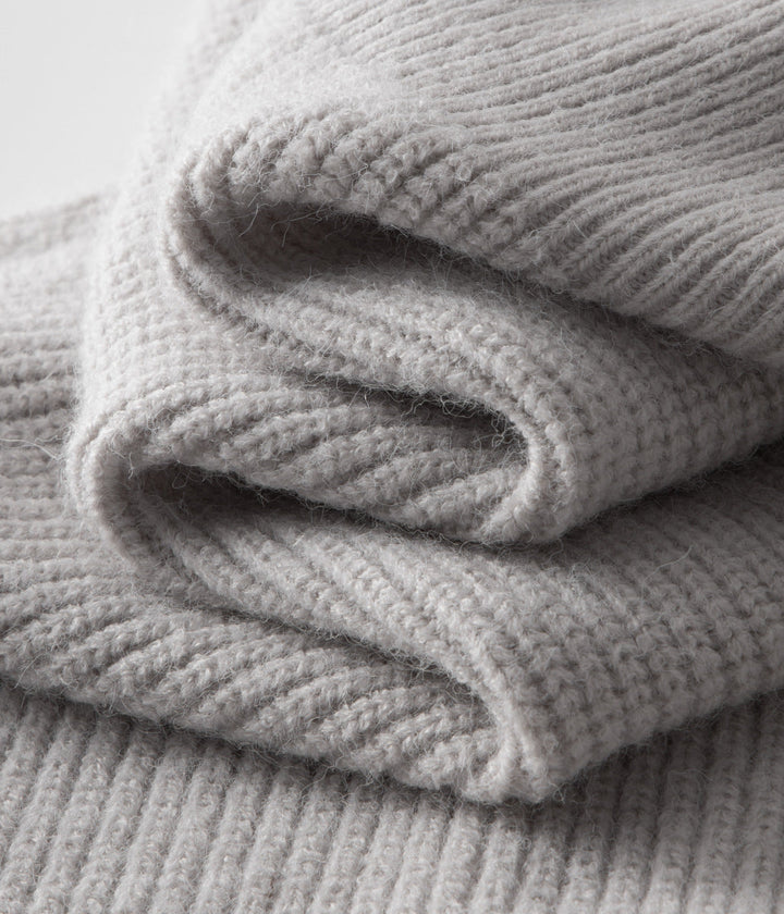 Man wearing a stylish funnel neck zip-up sweater. Perfect menswear for smart casual & casual layering.