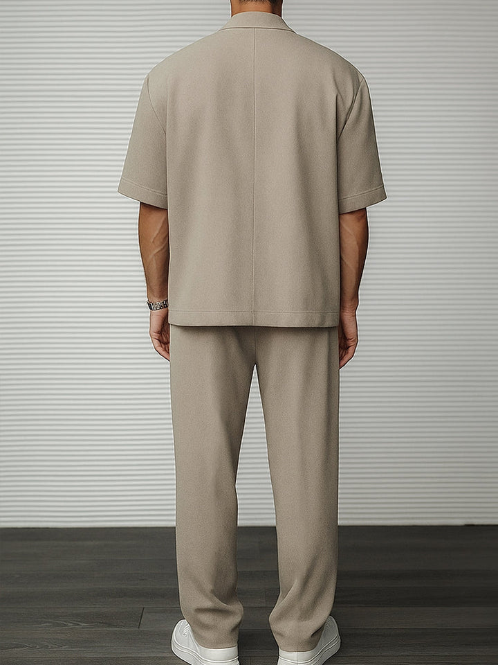 Sophisticated men's short sleeve blazer and matching tailored trousers suit set for stylish event attire. Modern formal wear.