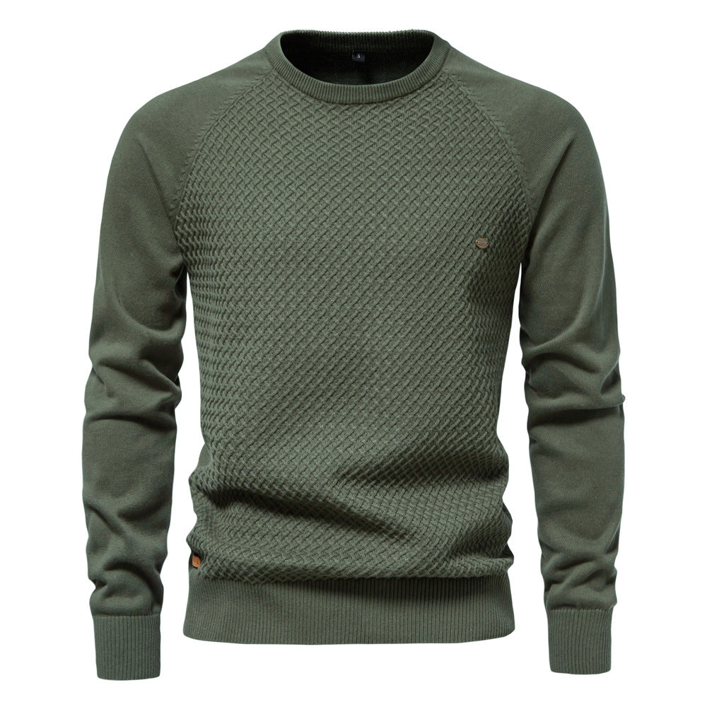 Man's hand touching the soft waffle knit fabric of a crewneck sweater, highlighting comfort