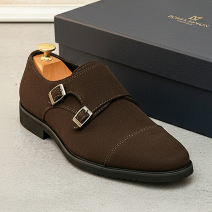 Detailed shot of the double buckle on a men's suede monk strap dress shoe.