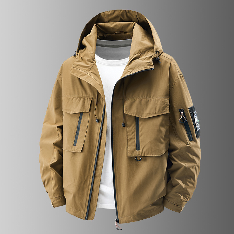 Close-up of a men's tactical outerwear jacket, showing zipper detail and sturdy all-weather material.