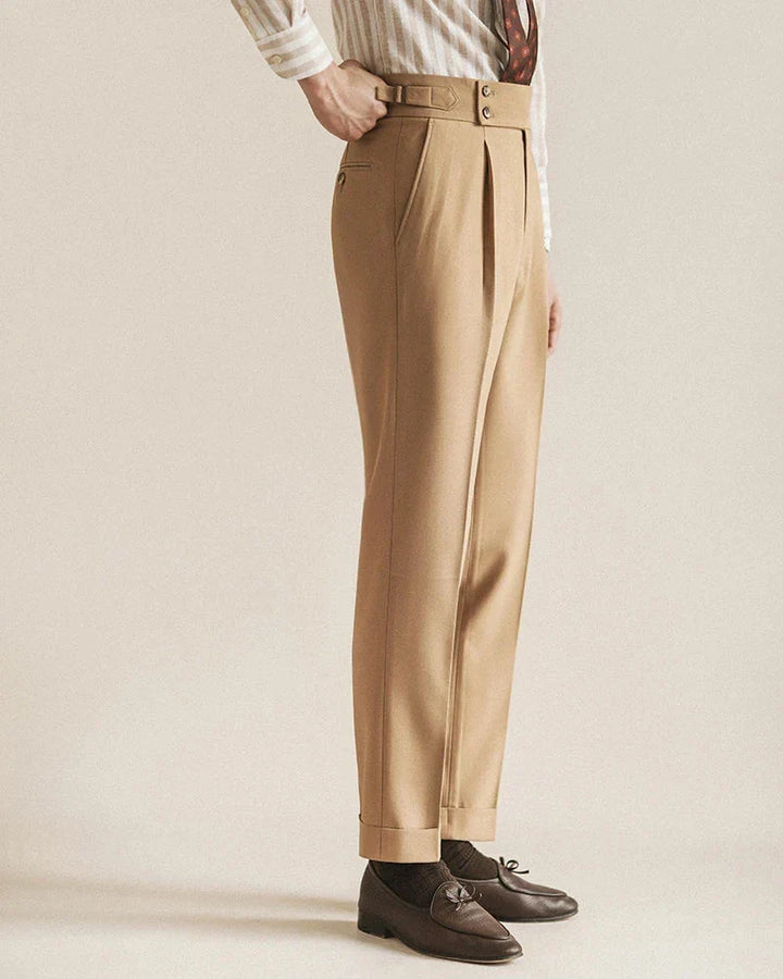 Detailed shot of the button and zipper closure on men's tailored business pants for formal wear.
