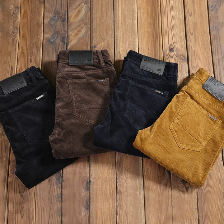 Full-length shot of men's corduroy tailored dress trousers, styled for a smart casual look.