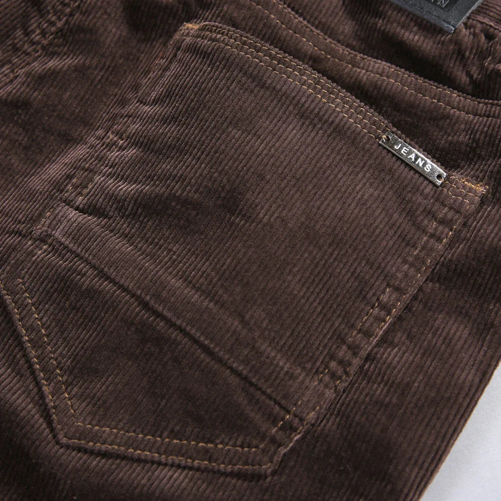 Dark grey men's corduroy trousers with a refined tailored fit, perfect for versatile winter outfits.