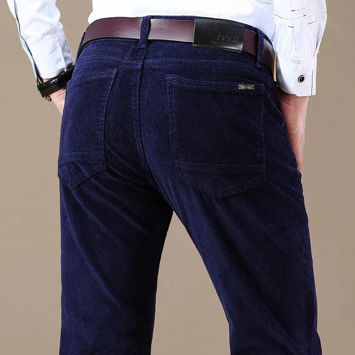 Model wearing men's corduroy tailored dress trousers, demonstrating a modern and comfortable fit.