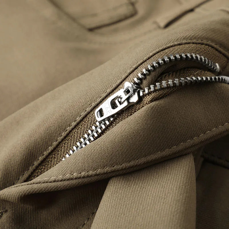 Detail of waistband and pockets on men's dark grey contemporary dress trousers, showing quality