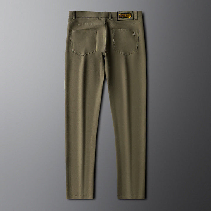 Stack of three men's contemporary dress trousers in dark grey, army green, and black, mensfashion