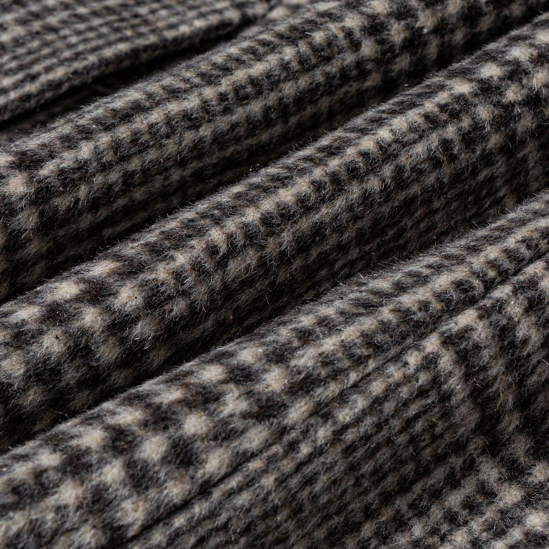 Detail of the collar and lapels on a men's plaid wool blend overcoat, highlighting tailoring