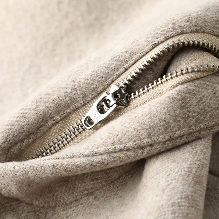 Close-up of the fabric texture on men's tailored khaki dress trousers.