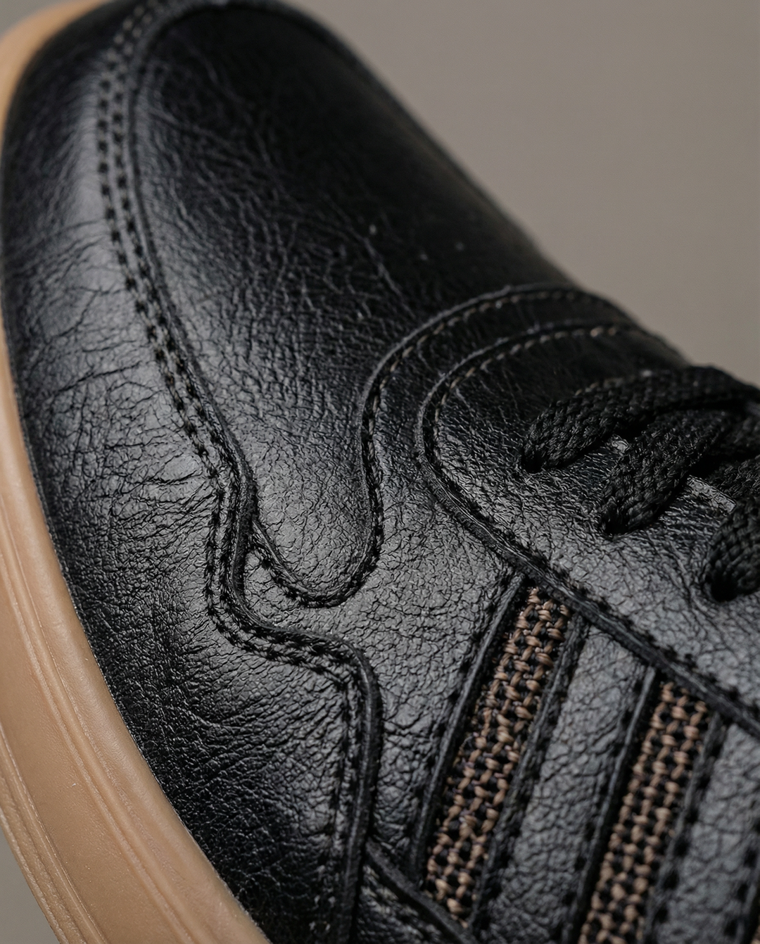 Men's classic black leather sneakers, offering comfort & durability for everyday fashion