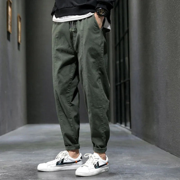Close-up of the cotton blend fabric on men's tapered joggers, perfect for everyday athletic wear.