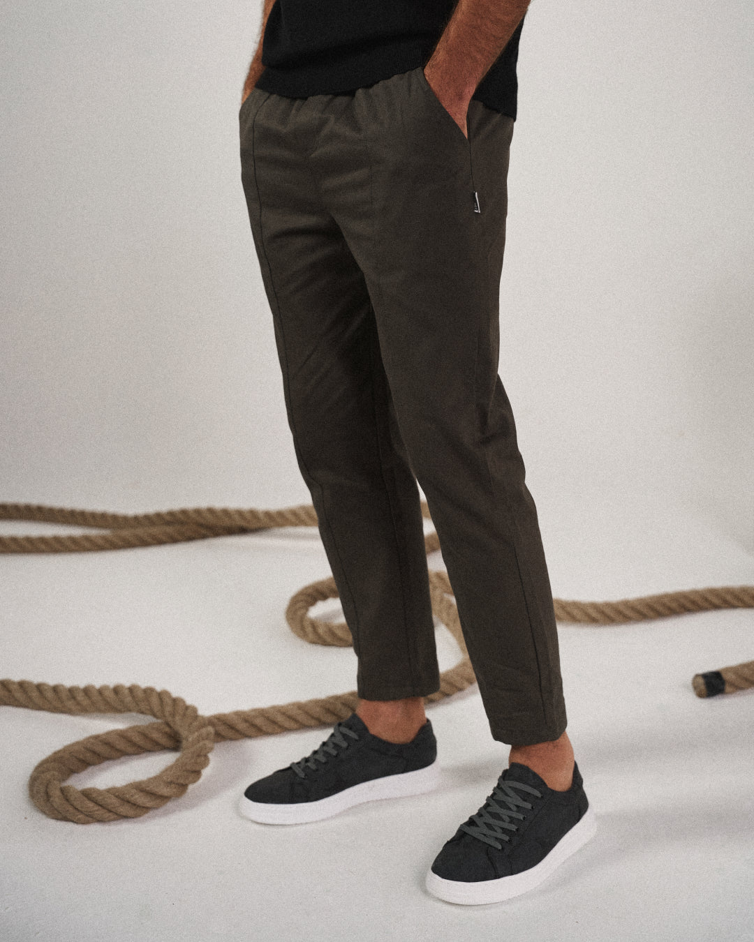 Detailed shot of the elastic waistband and drawstring on men's relaxed fit tapered joggers.