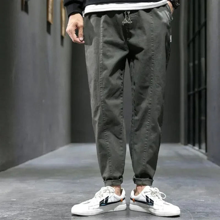Close-up of the ankle cuff on men's tapered joggers, a key feature for athletic pants.
