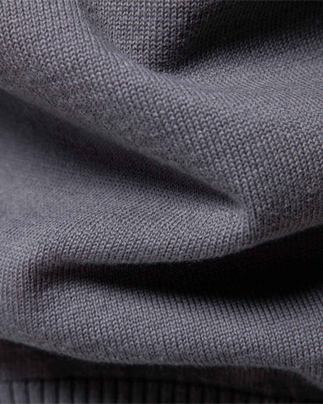 Close-up of the sleeve cuff on a men's long sleeve textured knit pullover