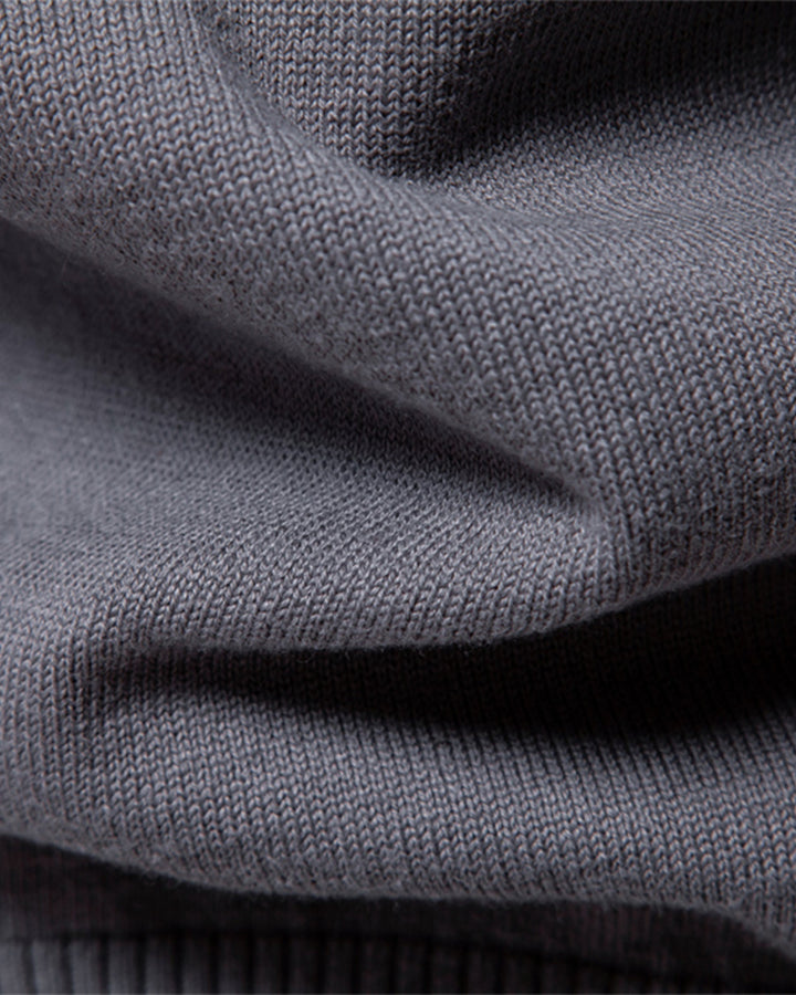 Close-up of the sleeve cuff on a men's long sleeve textured knit pullover