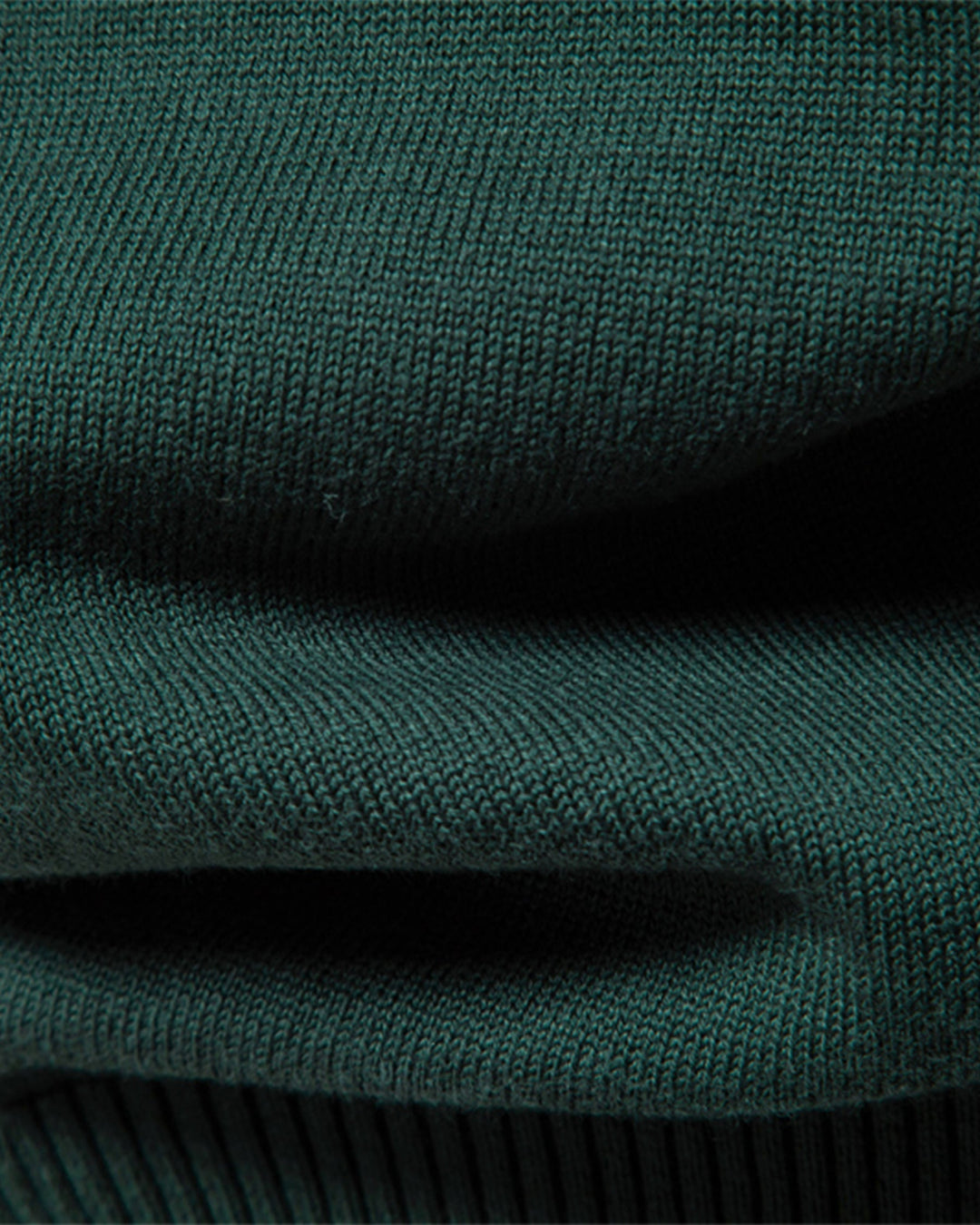 Close-up, showing the soft feel of the premium knit men's crew neck sweater