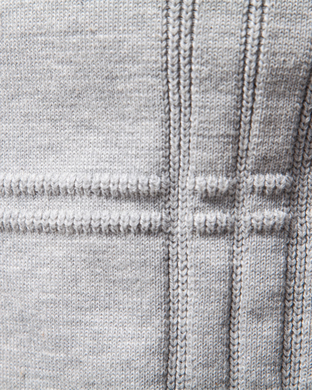 Men's fashion staple: a blue textured knit crew neck pullover draped over a chair